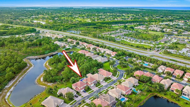 birds eye view of property featuring a water view and a residential view