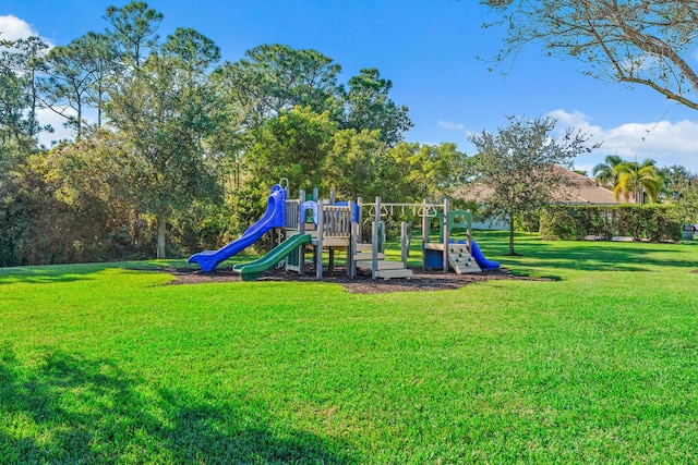 community jungle gym featuring a yard