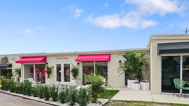 view of front of property with a patio area and french doors