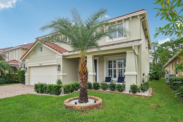 view of front of house featuring an attached garage, stucco siding, a front lawn, a tile roof, and decorative driveway