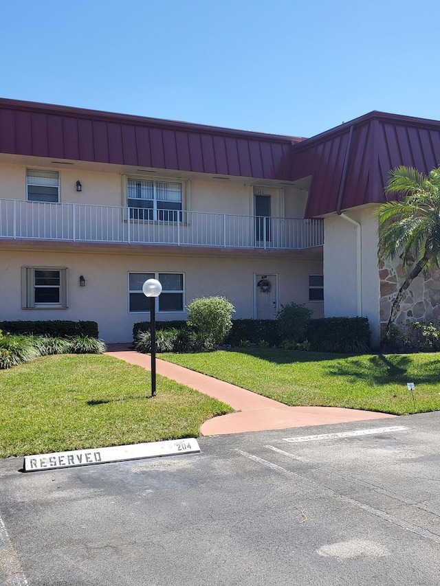 view of property featuring uncovered parking