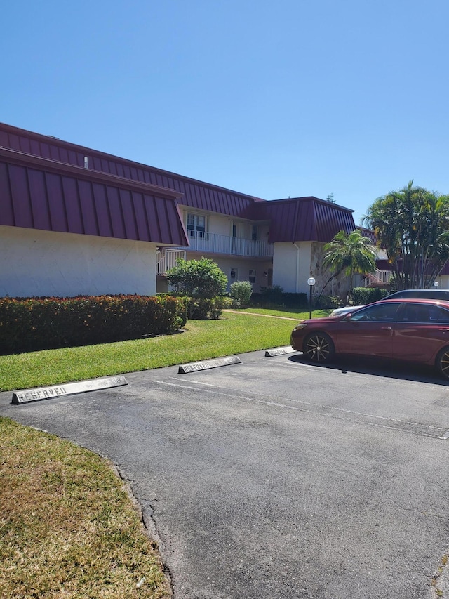 view of property featuring uncovered parking