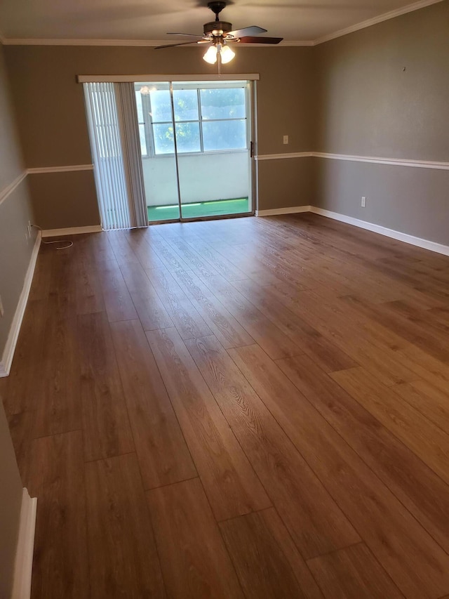 unfurnished room featuring ornamental molding, baseboards, and wood finished floors