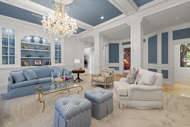 living room with a decorative wall, crown molding, ornate columns, and built in features