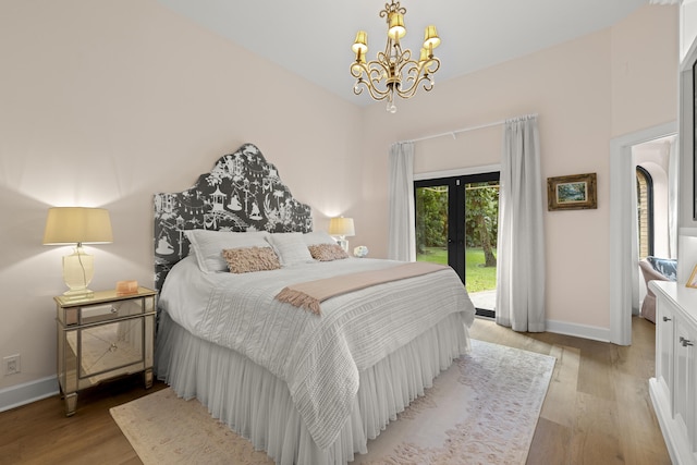 bedroom with baseboards, access to exterior, french doors, a notable chandelier, and light wood-type flooring