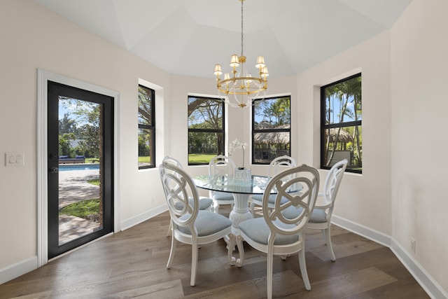 dining space featuring a healthy amount of sunlight, baseboards, lofted ceiling, and wood finished floors