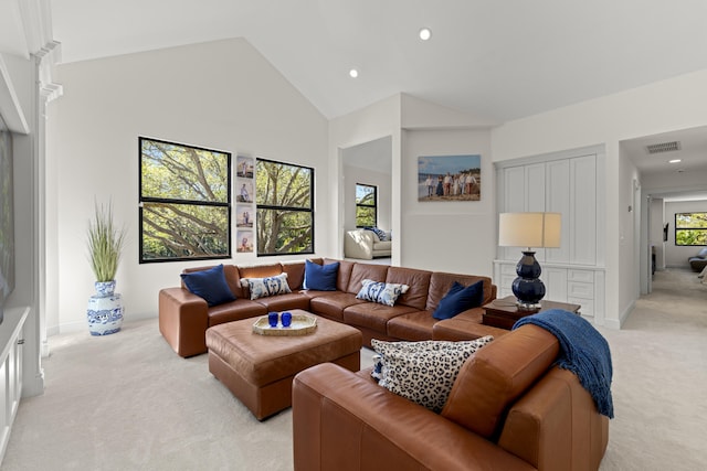 living area with baseboards, visible vents, high vaulted ceiling, recessed lighting, and light colored carpet