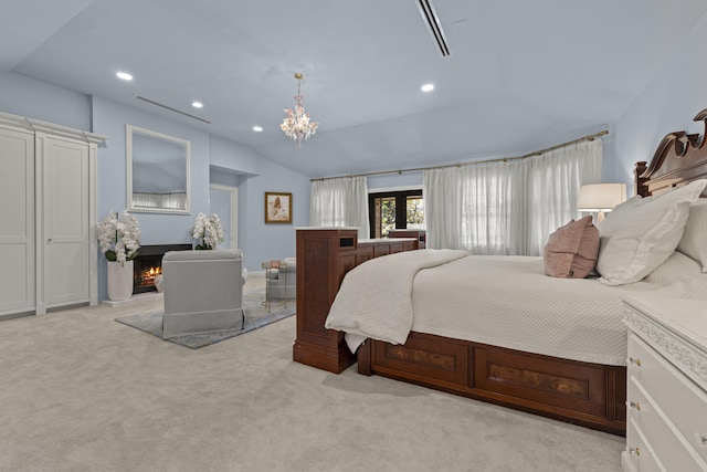 carpeted bedroom with lofted ceiling, a notable chandelier, recessed lighting, and a lit fireplace