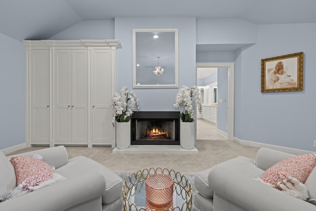 living area with lofted ceiling, light colored carpet, baseboards, and a lit fireplace