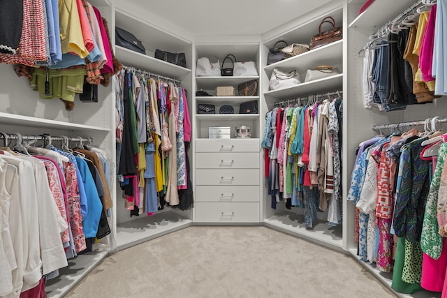 walk in closet with carpet flooring