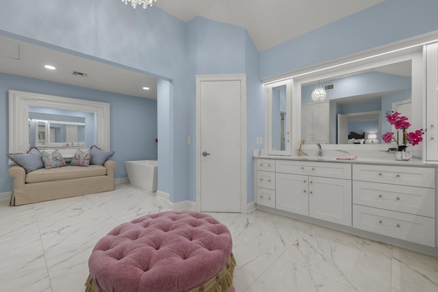 bathroom featuring visible vents, baseboards, marble finish floor, and a freestanding bath