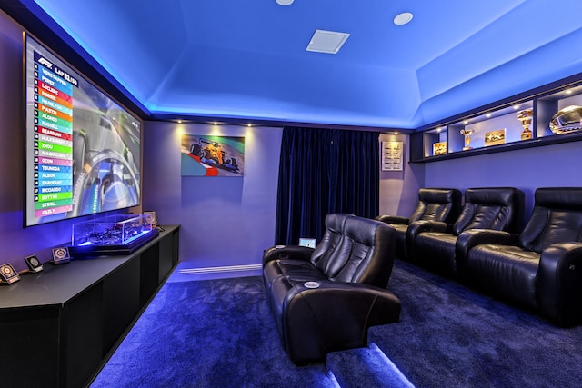 home theater room with lofted ceiling and dark colored carpet