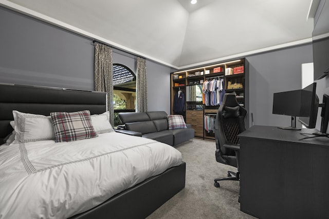 carpeted bedroom with a closet and high vaulted ceiling