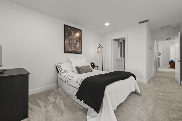 bedroom featuring visible vents, baseboards, and light colored carpet