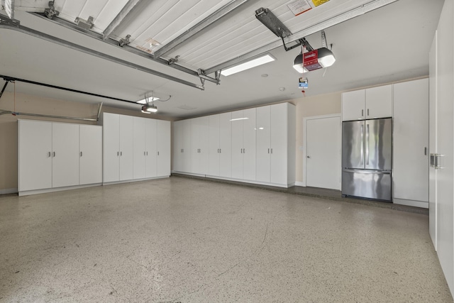 garage featuring a garage door opener and stainless steel fridge