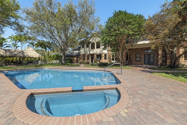 view of swimming pool with a pool with connected hot tub