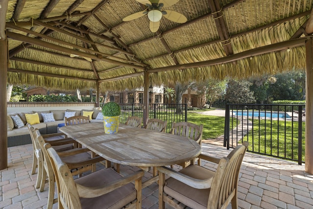 view of patio featuring a gazebo, a fenced in pool, outdoor dining space, and ceiling fan