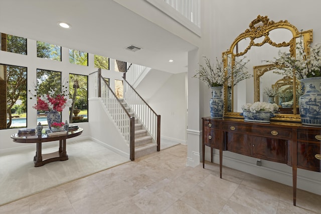 entryway with stairway, recessed lighting, visible vents, and baseboards