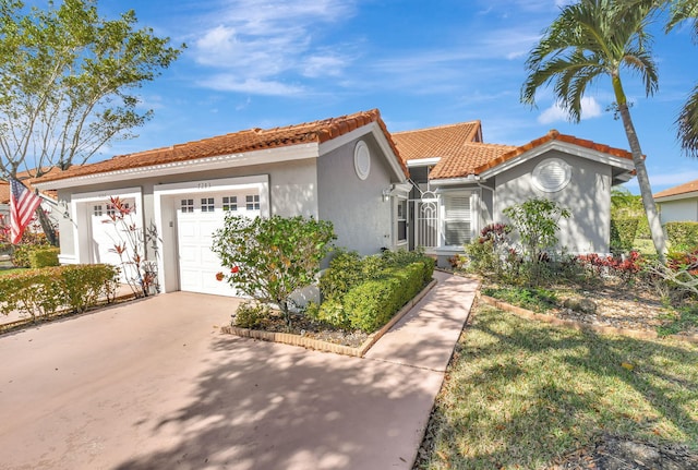 mediterranean / spanish-style house with a garage