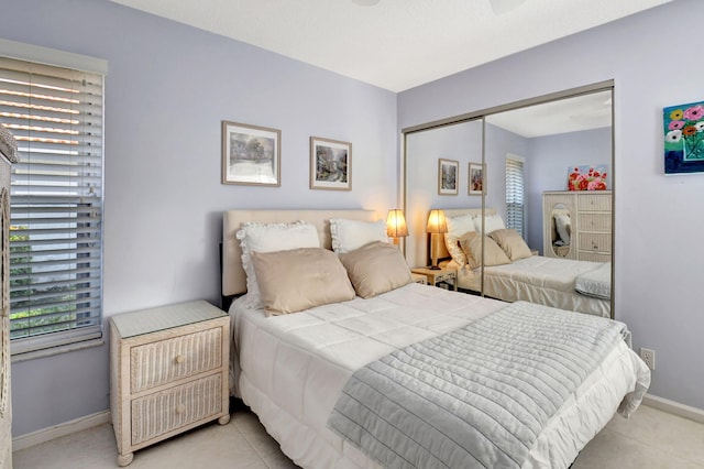 bedroom with multiple windows and a closet