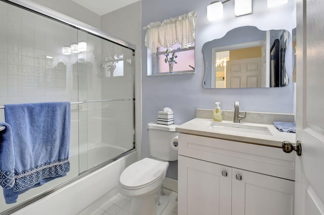 full bathroom featuring vanity, enclosed tub / shower combo, and toilet