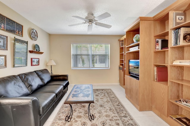 tiled living room featuring ceiling fan and a textured ceiling