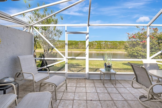 unfurnished sunroom featuring a water view