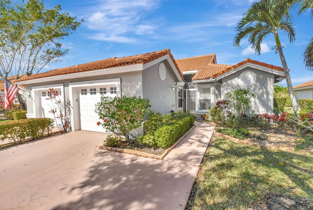 view of front of house featuring a garage and a front lawn