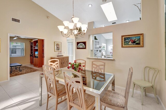 kitchen with pendant lighting, light tile patterned floors, ceiling fan with notable chandelier, and white cabinets