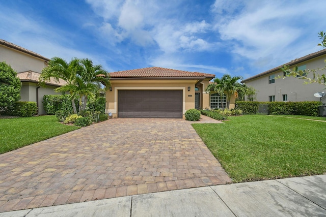 mediterranean / spanish house featuring a garage and a front lawn