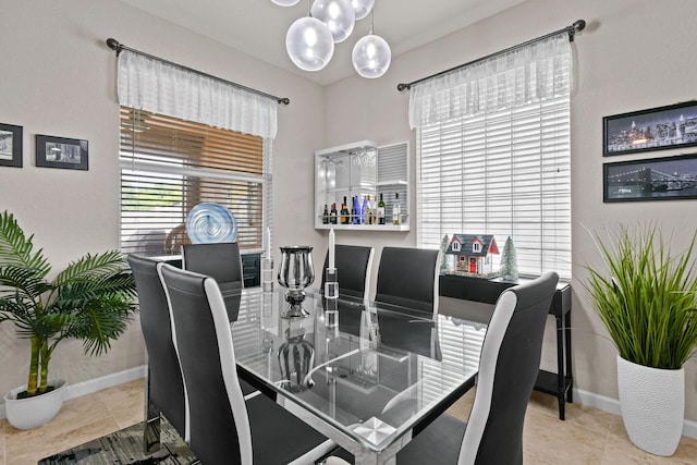 dining room featuring light tile patterned floors and a notable chandelier