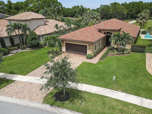 view of front of house with a garage and a front yard