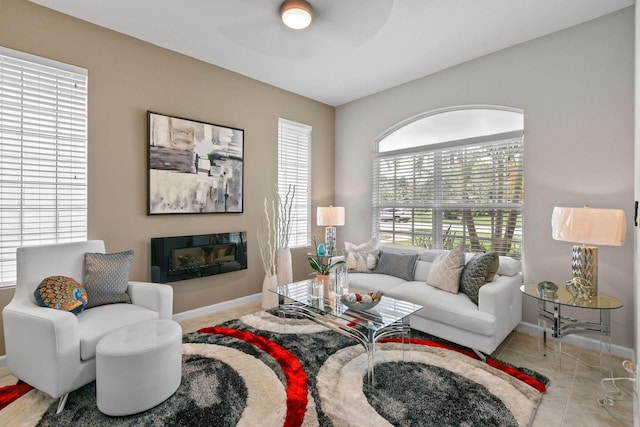 living room with light tile patterned floors and ceiling fan