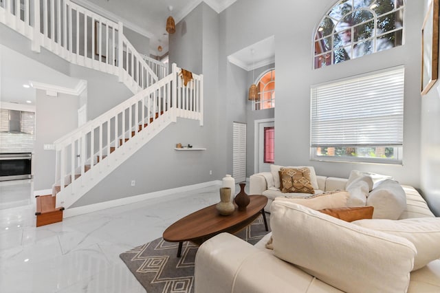 living room featuring ornamental molding and a high ceiling