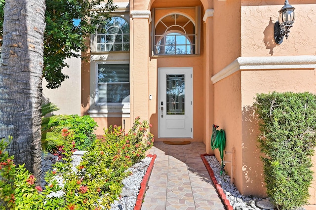 entrance to property with stucco siding