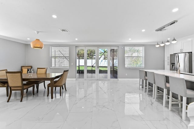 dining area featuring crown molding and french doors