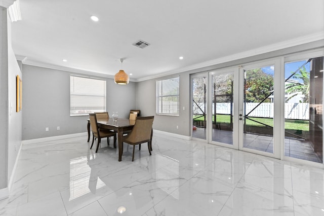 dining area with crown molding and french doors