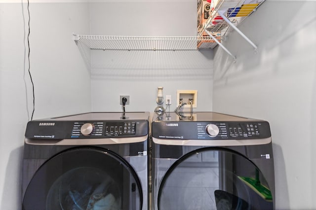 clothes washing area featuring washing machine and dryer and laundry area