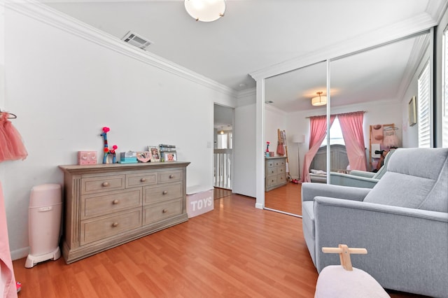 interior space with light wood-style floors, visible vents, and ornamental molding