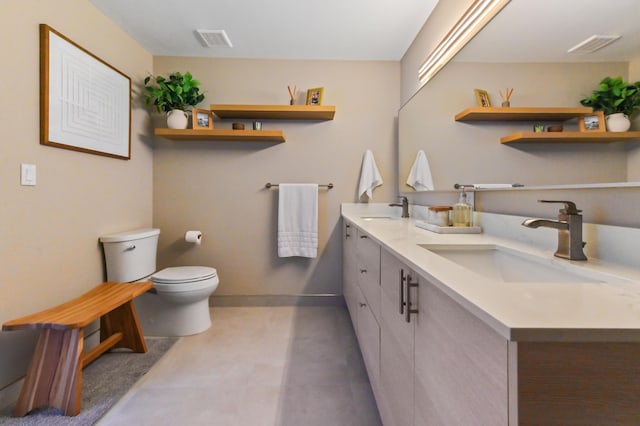 bathroom with double vanity, visible vents, and a sink