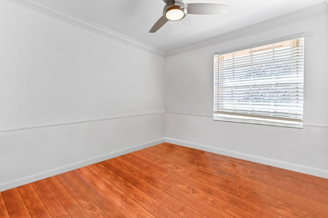 unfurnished room featuring baseboards, a ceiling fan, crown molding, and wood finished floors