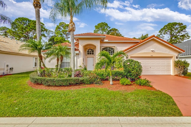 mediterranean / spanish home with a garage and a front yard