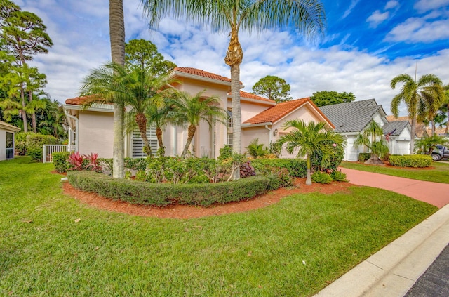 mediterranean / spanish home featuring a front lawn