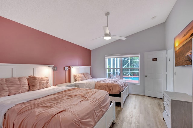 bedroom featuring ceiling fan, lofted ceiling, and light wood-type flooring