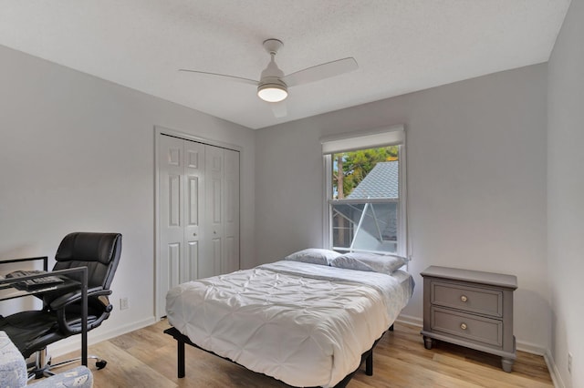 bedroom featuring ceiling fan, a closet, and light hardwood / wood-style flooring