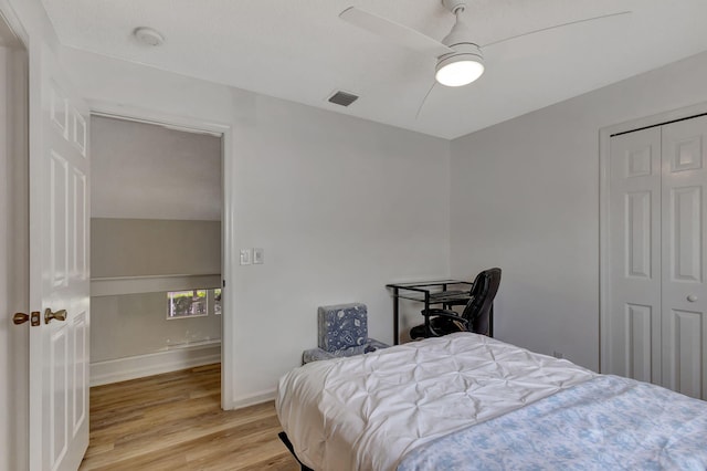 bedroom with light hardwood / wood-style flooring, a closet, and ceiling fan