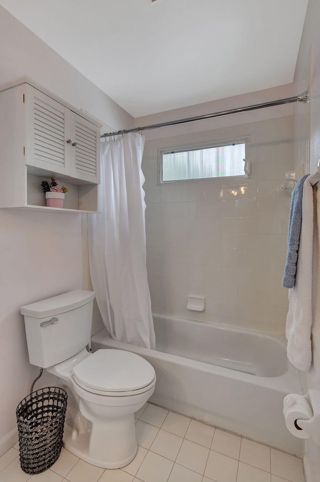 bathroom with tile patterned floors, shower / bath combination with curtain, and toilet