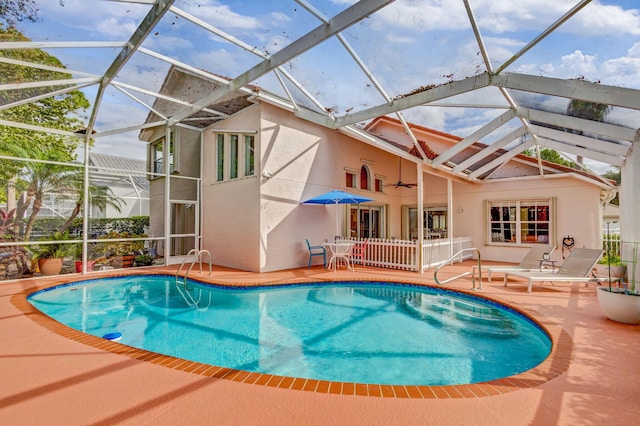 view of swimming pool with a patio area and glass enclosure