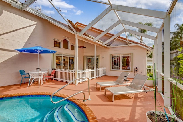 view of pool featuring a patio area, ceiling fan, and glass enclosure