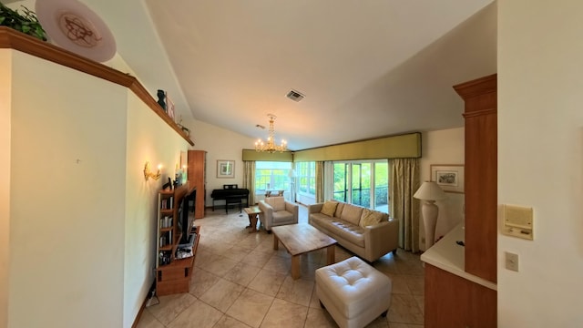 living room with lofted ceiling, light tile patterned floors, and a chandelier